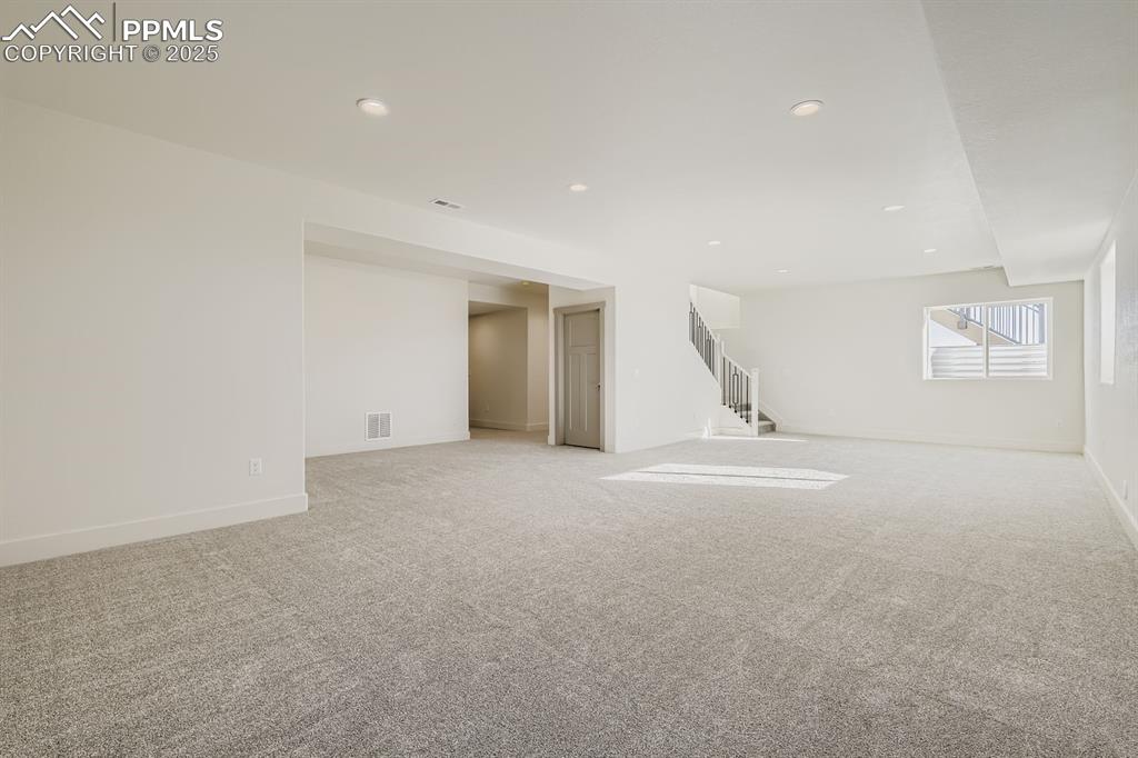 Image 17 of 41: Spacious family/rec room with a clear view toward the bedroom corridor—perf