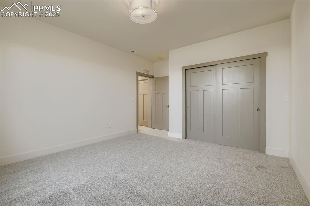 Image 19 of 41: Second basement bedroom offering excellent privacy and comfort, perfect for