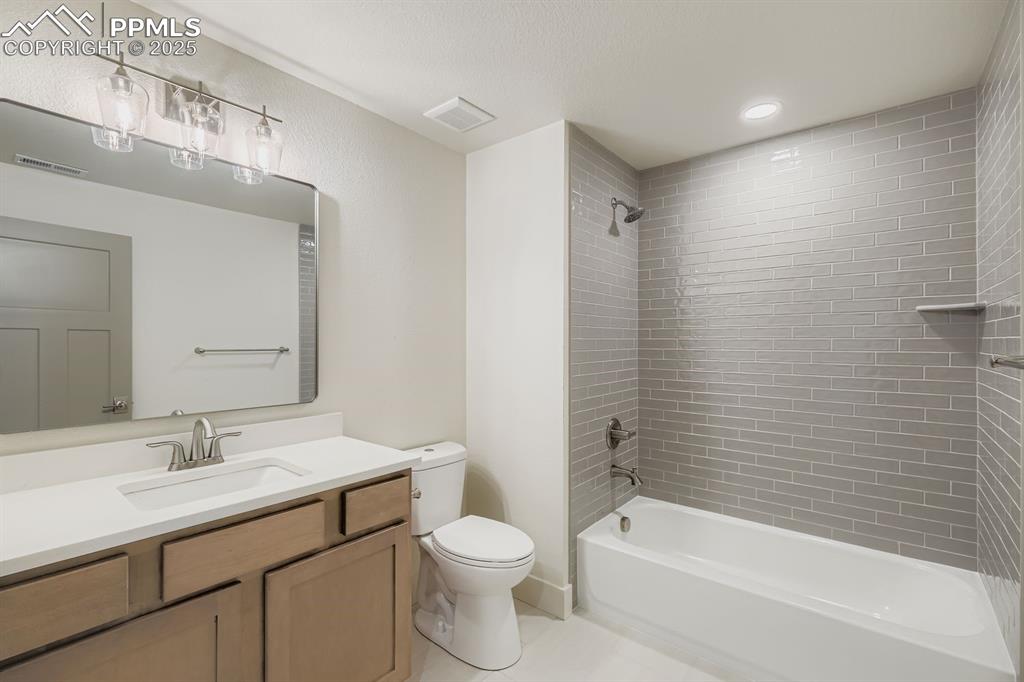 Image 21 of 41: Full bathroom situated between basement bedrooms, providing convenient acce