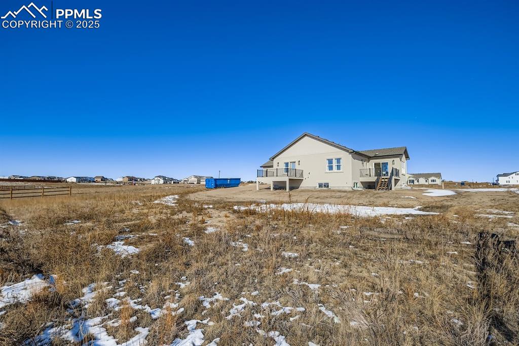 Image 46 of 50: Back of home showcasing yard space and outdoor possibilities.