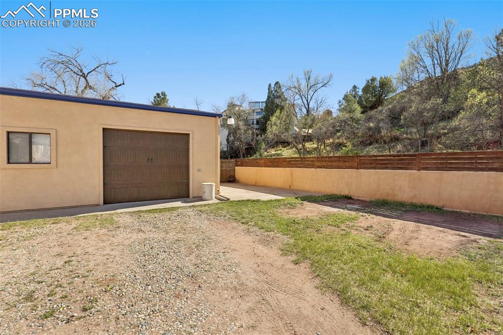 Image 8 of 50: RV parking on side of garage