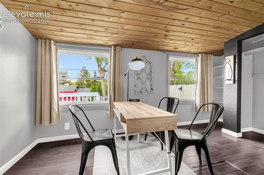 Image 10 of 21: Wood-finish plank ceiling with dark wood-finish flooring