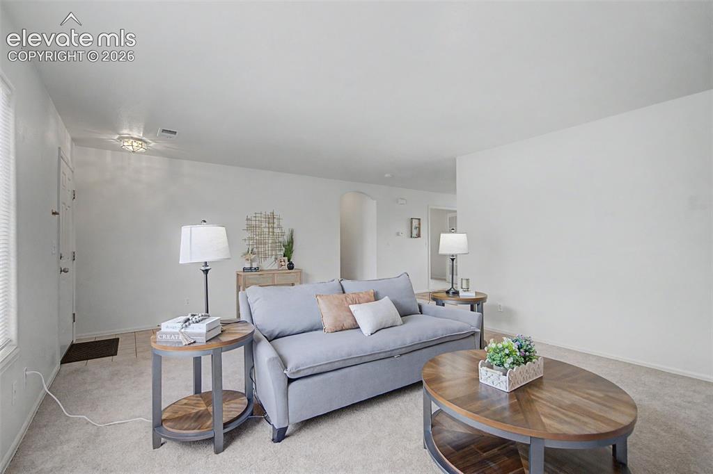 Image 4 of 22: Spacious Living Room with Natural Light