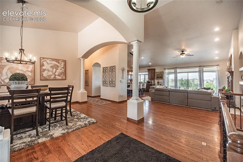 Image 3 of 50: Open-concept interior featuring wood-finish flooring, vaulted ceilings, and