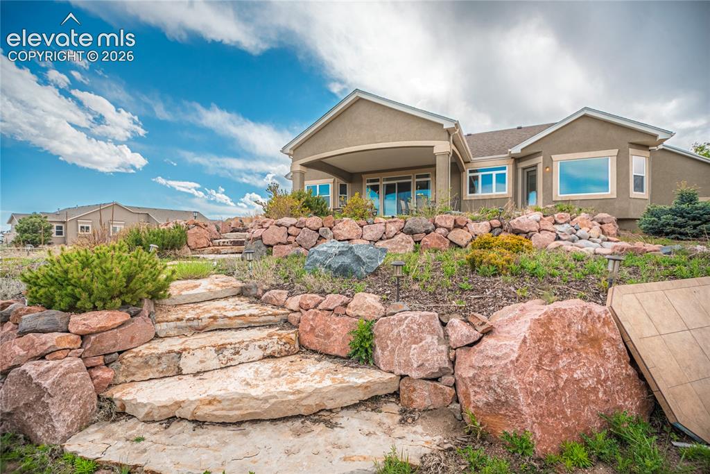 Image 40 of 50: Terraced landscaping with natural stone steps and accent boulders