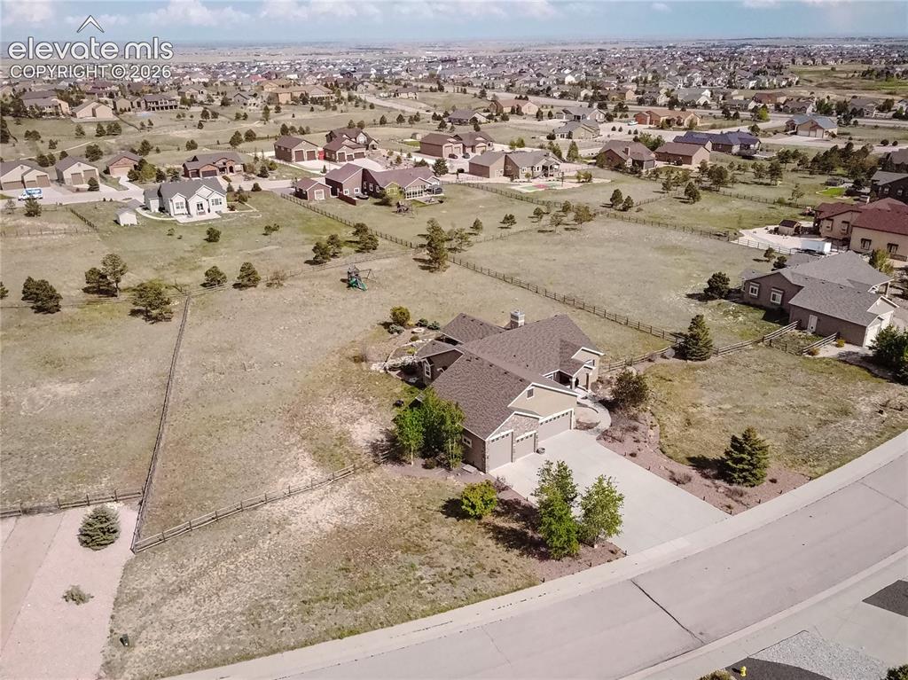 Image 42 of 50: Expansive property featuring a large multi-car driveway, attached three-car