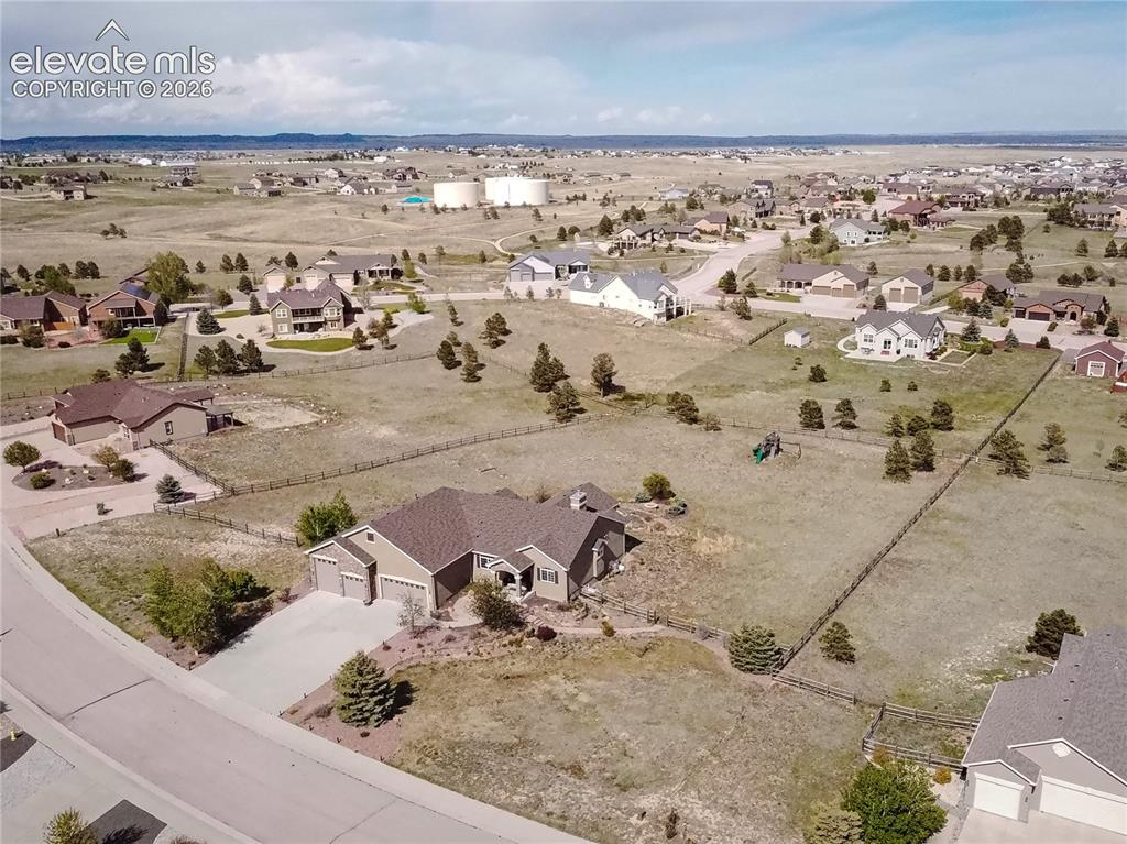 Image 43 of 50: Spacious property featuring a two-car garage, concrete driveway, and establ