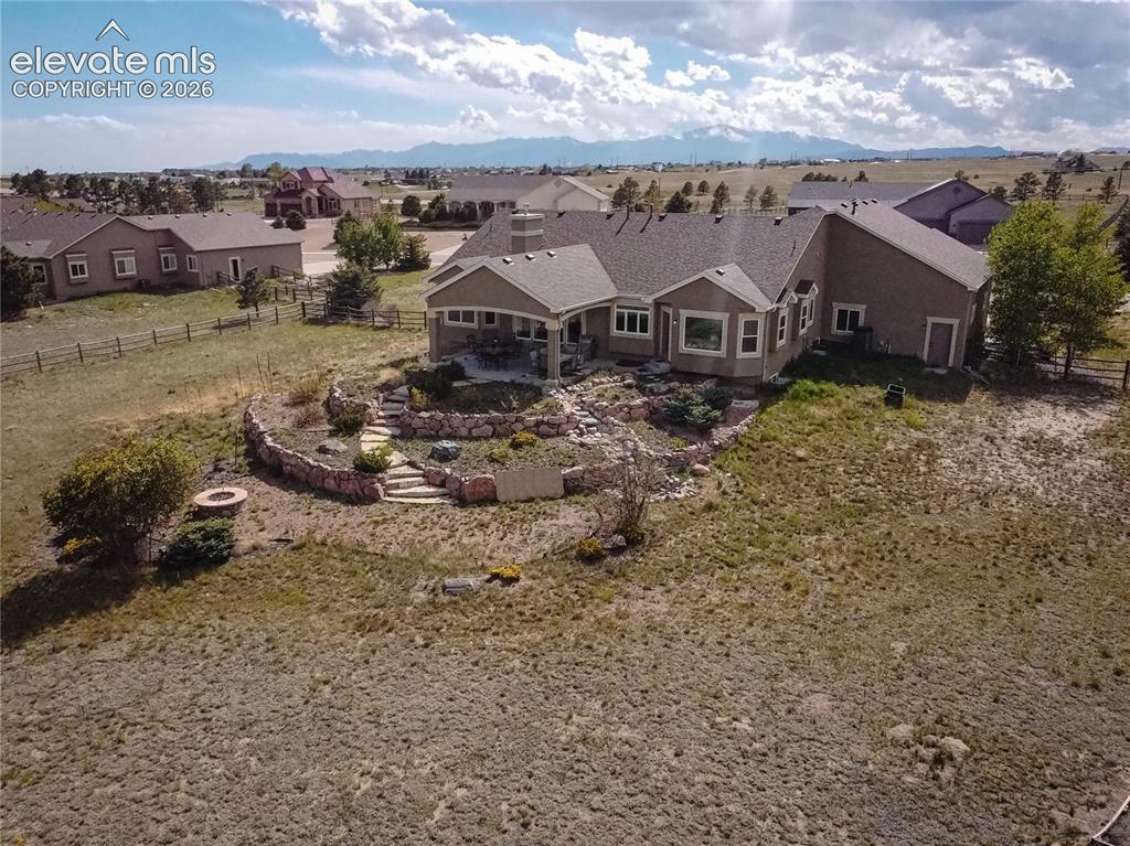 Image 50 of 50: Spacious ranch-style residence featuring a covered patio, terraced rock lan