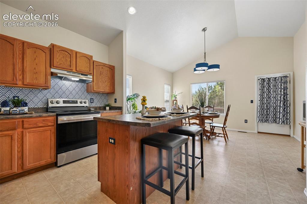 Image 11 of 32: Large open kitchen with island for additional counter and seating space