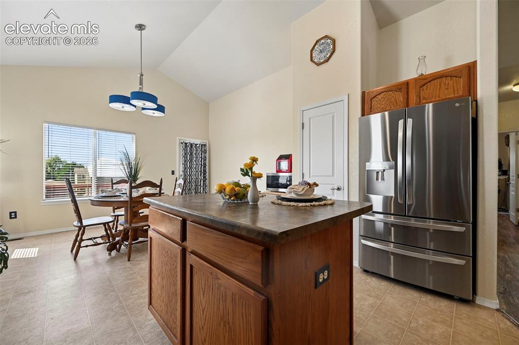 Image 14 of 32: Kitchen flows smoothly into large dining area.