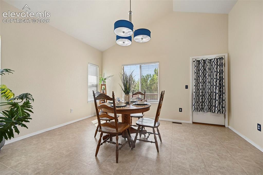 Image 15 of 32: Large dining room with walkout to beautiful wood deck.