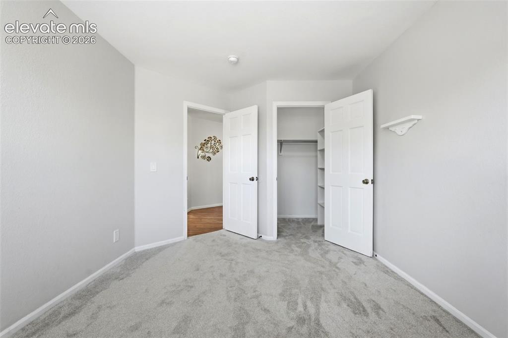 Image 28 of 43: Room featuring light gray carpet flooring and white baseboards