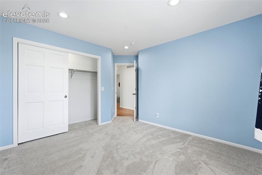 Image 30 of 43: Light blue walls complement the light-toned carpeting in this room