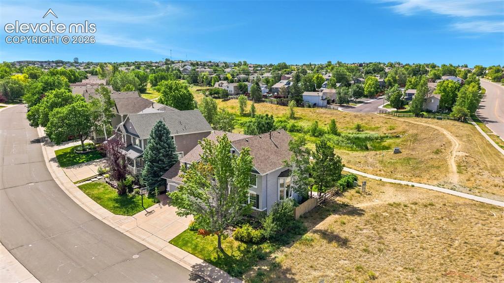 Image 39 of 43: Residential neighborhood featuring mature trees, paved streets, and a natur