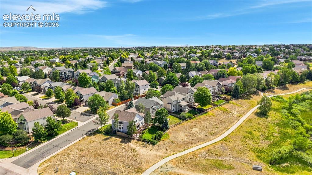 Image 41 of 43: Expansive residential area featuring numerous single-family homes, mature t