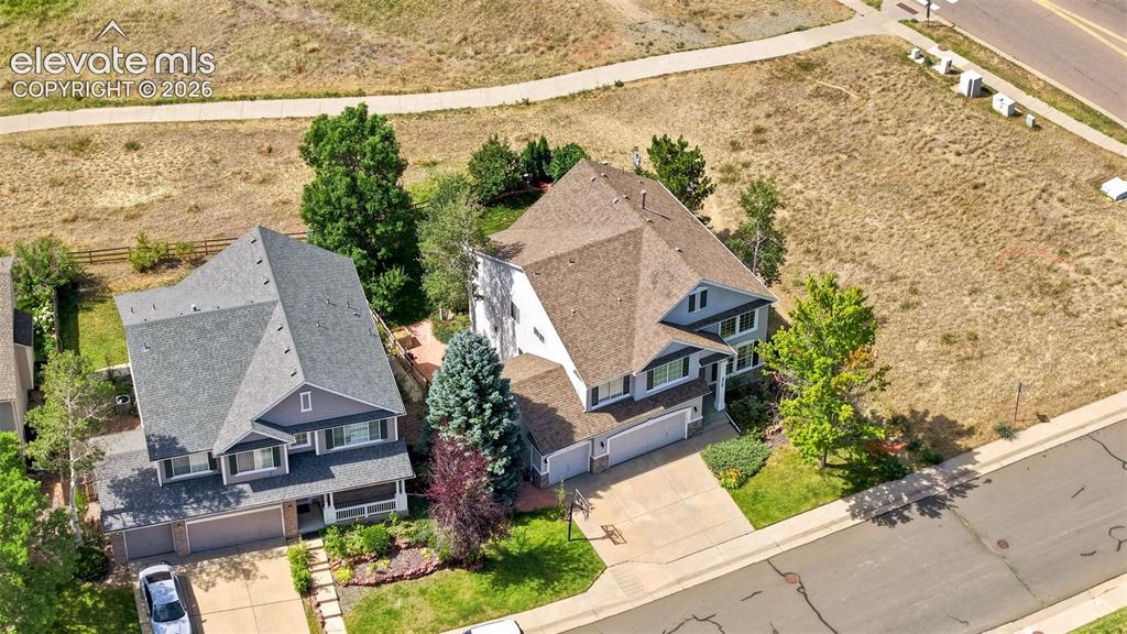 Image 43 of 43: Two-story home with a tan shingle roof and light blue siding