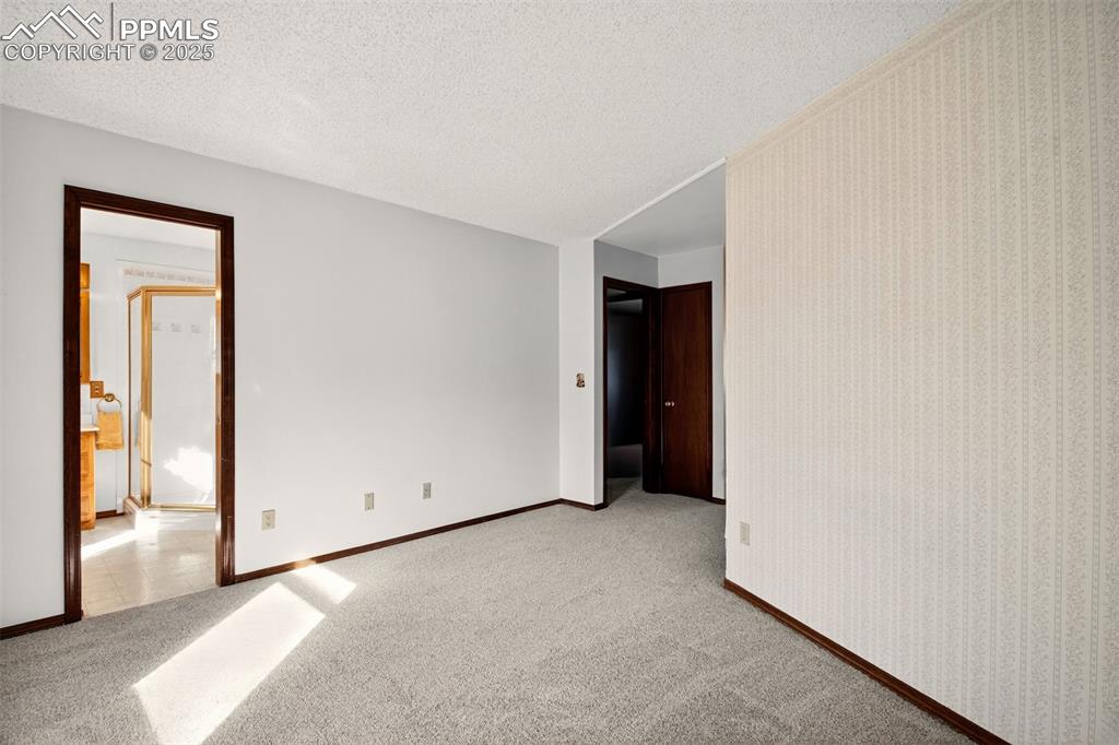 Image 20 of 50: Primary Bedroom Suite "Sitting Area" toward Primary Bathroom and entry to P