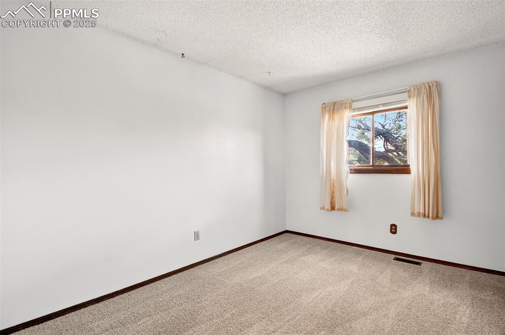 Image 25 of 50: 2nd Bedroom with Full Bathroom across hall on upper level