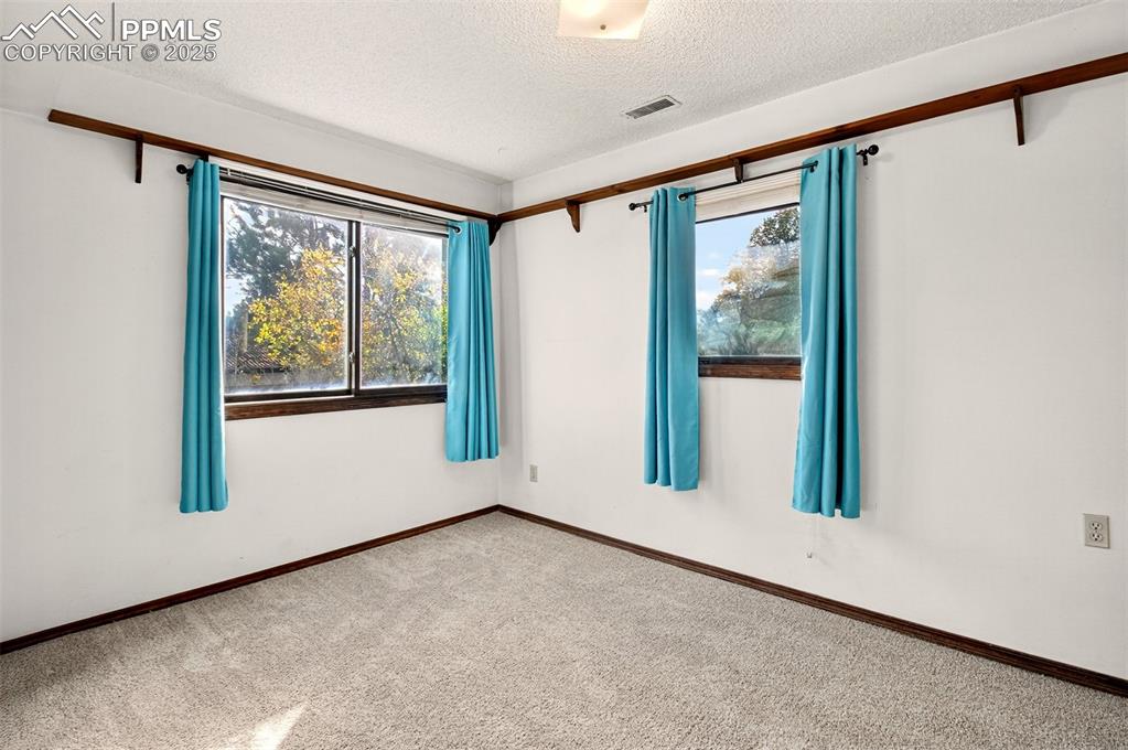 Image 33 of 50: 3rd Bedroom located on the lower level would also make a great Office and h