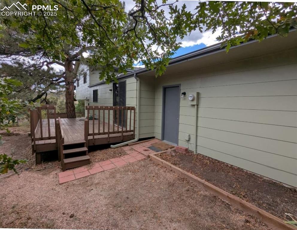 Image 42 of 50: Back of home and pedestrian door to back of garage