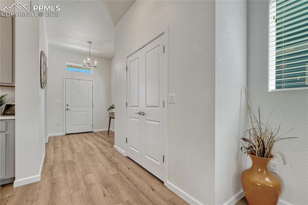 Image 4 of 50: Enter into the home and be greeted with tall ceilings and bright spaces