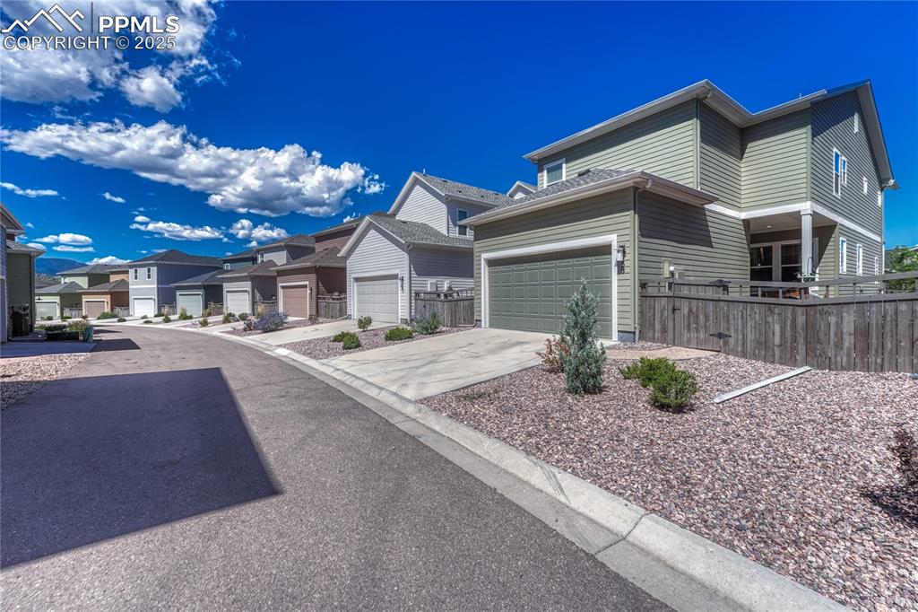 Image 45 of 50: Access to the 2-car attached garage comes from the back “alley” road that o