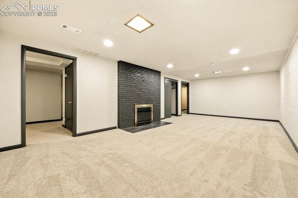 Image 24 of 35: HUGE Basement Rec room with fireplace