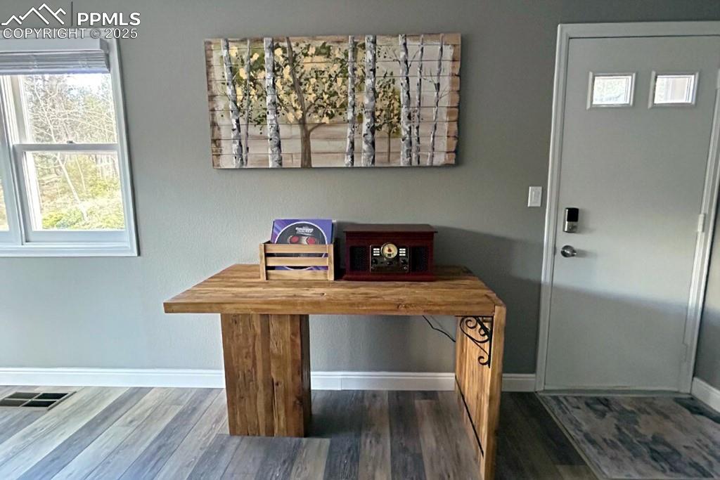 Image 3 of 50: Entryway with wood finished floors and baseboards