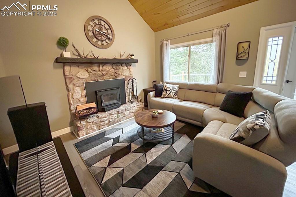 Image 4 of 50: Living area featuring wood finished floors, wood ceiling, and high vaulted