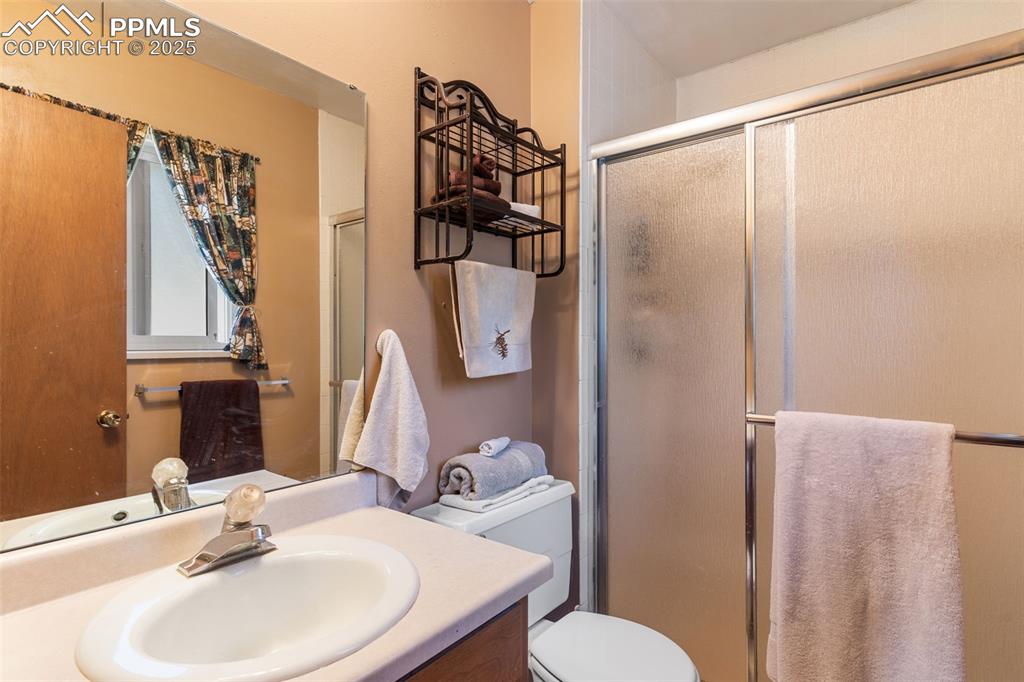 Image 19 of 35: Full bath with vanity and a stall shower