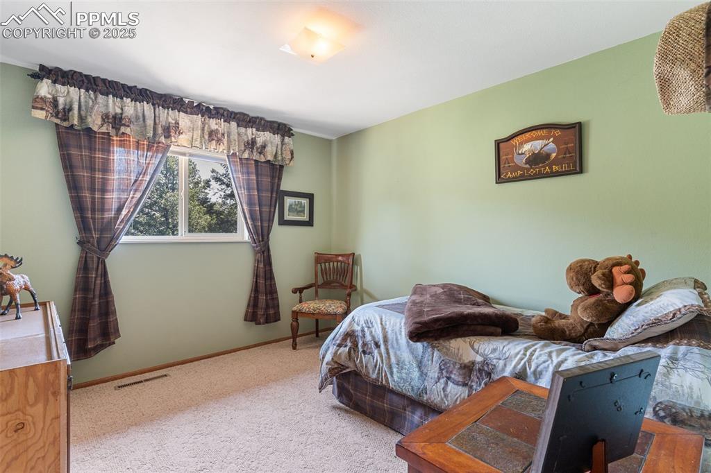 Image 23 of 35: Bedroom featuring light carpet and baseboards
