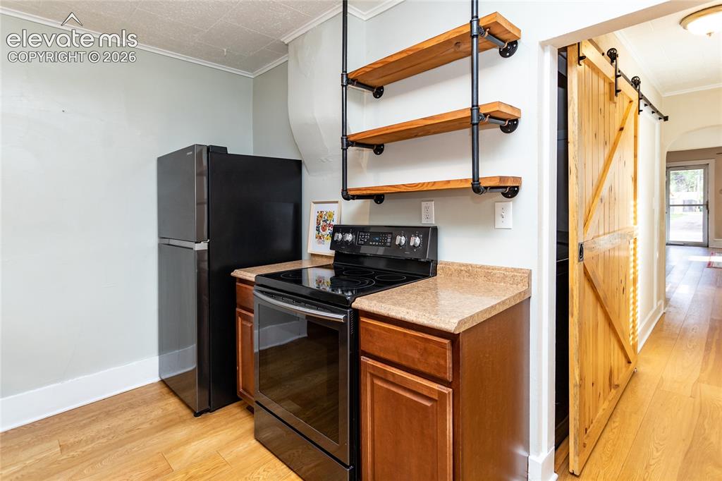 Image 29 of 44: Newer appliances and custom shelves
