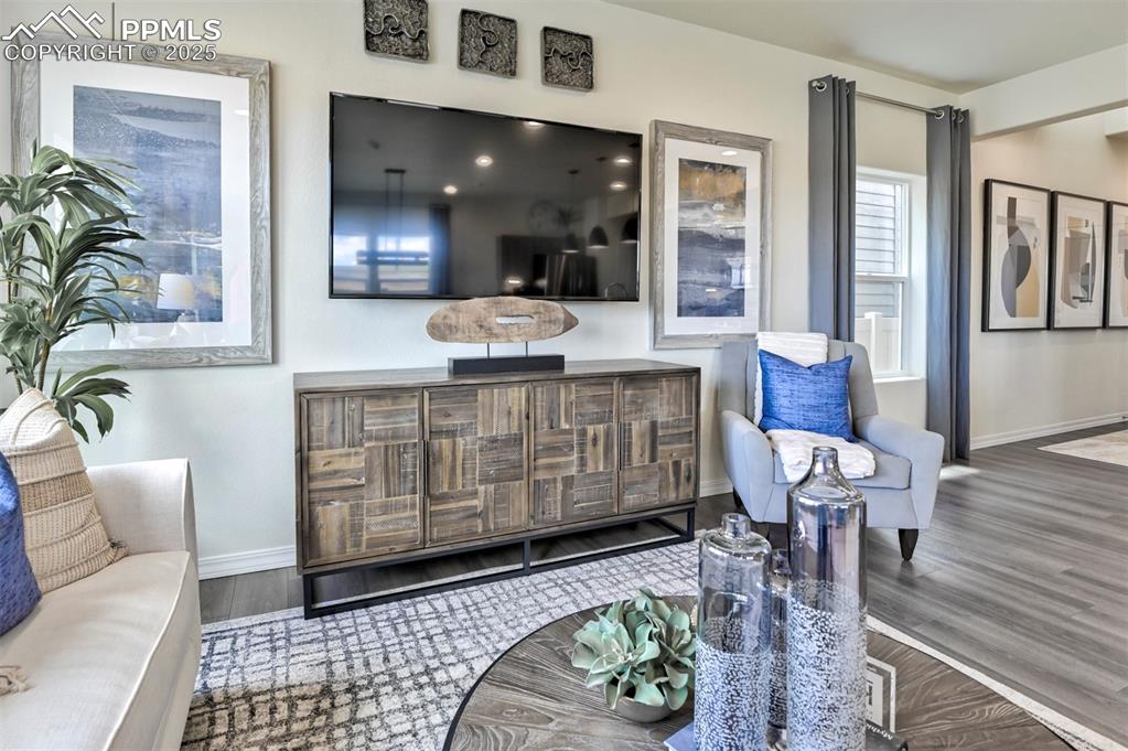 Image 4 of 35: Living area featuring baseboards and wood finished floors