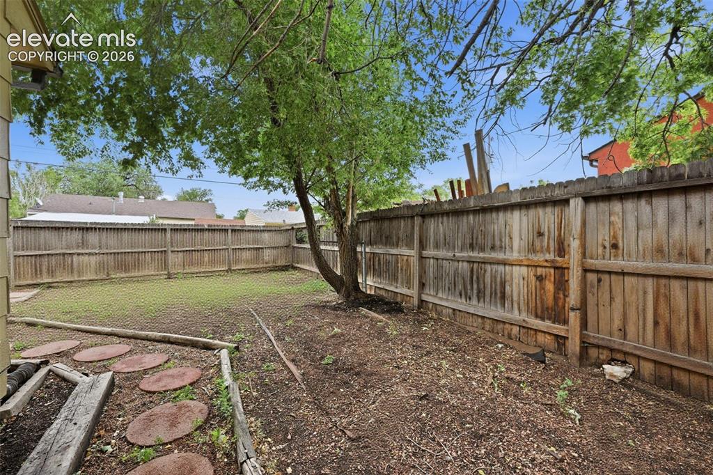 Image 16 of 22: Side yard reimagined without the fencing.