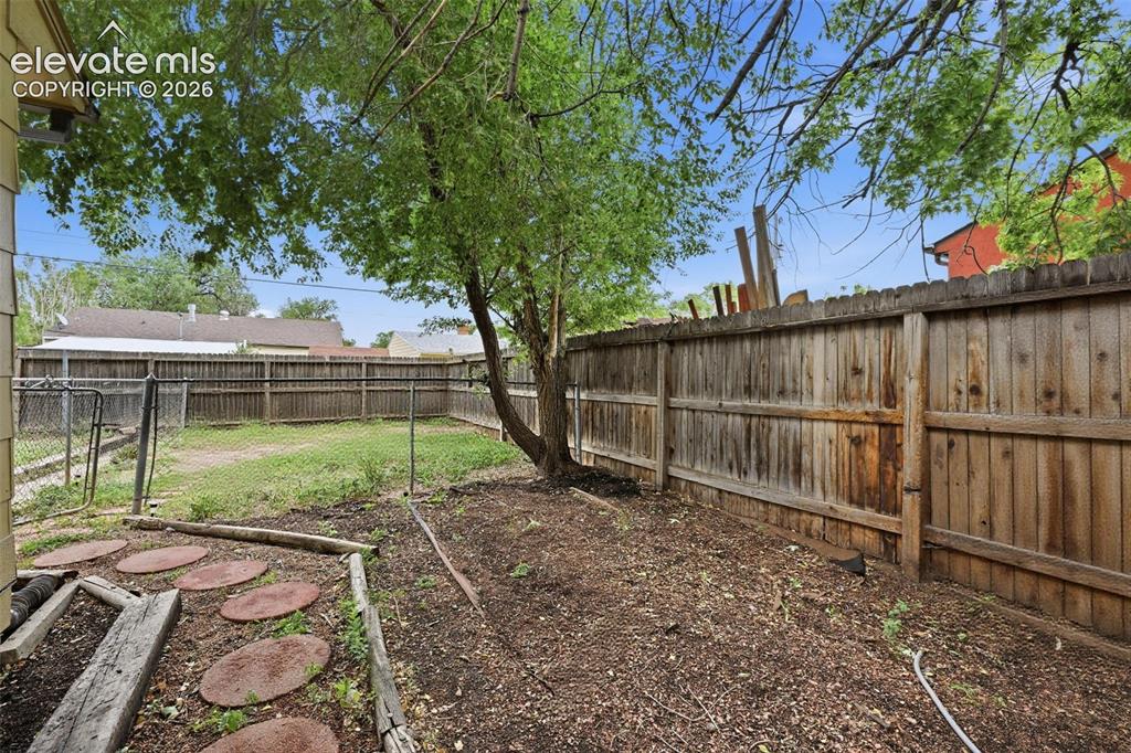 Image 17 of 22: Side yard showing the fencing could be used for pets