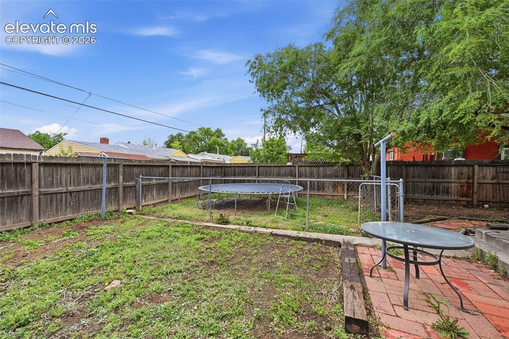 Image 21 of 22: Backyard small fenced area could be used for pets.