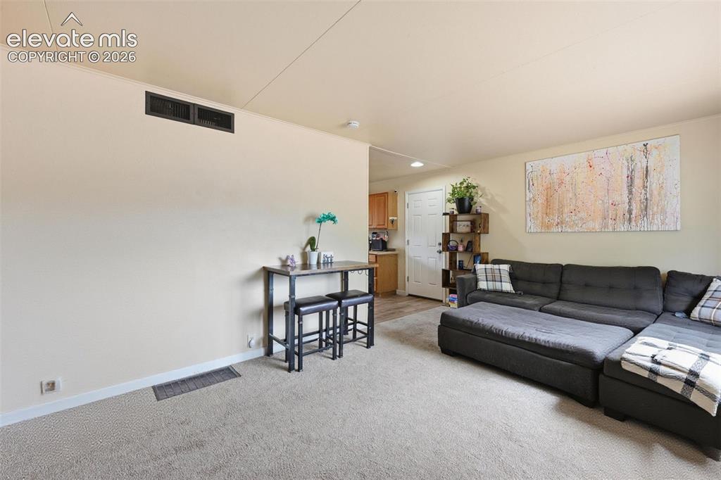 Image 9 of 22: Living room facing kitchen