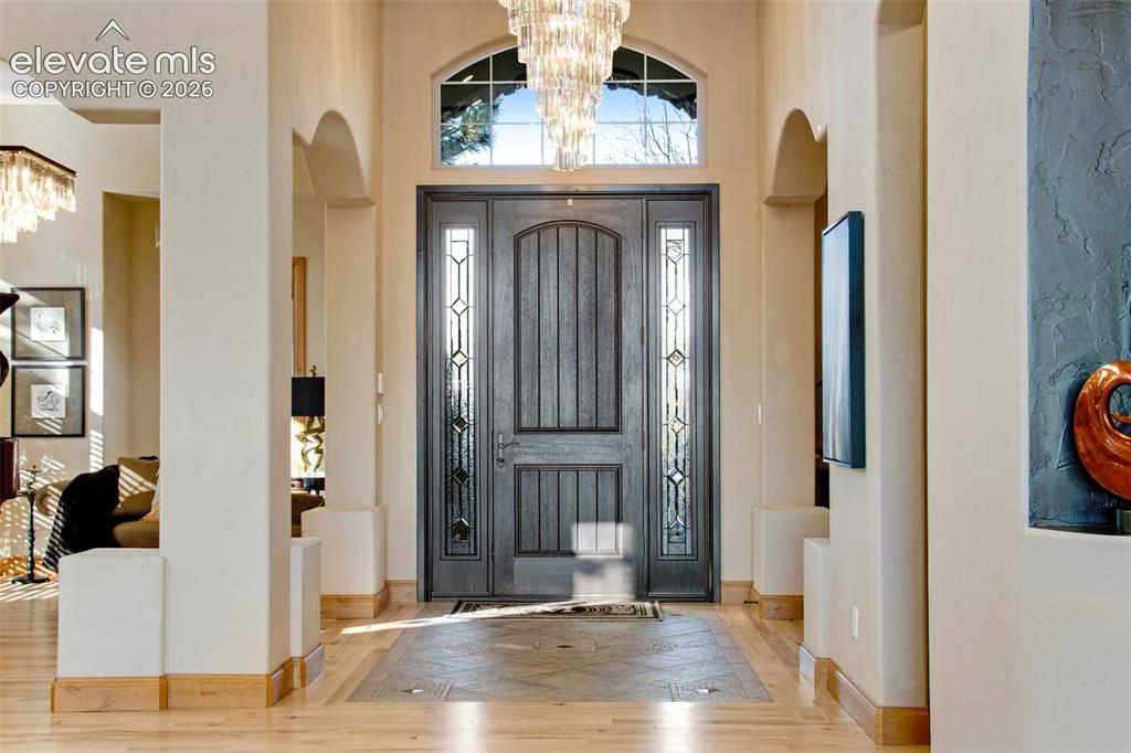 Image 13 of 50: Grand and spacious foyer featuring tile inlay