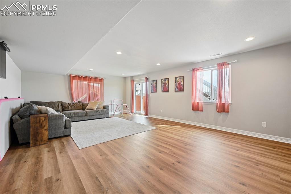 Image 25 of 41: basement family room- sliders to the backyard