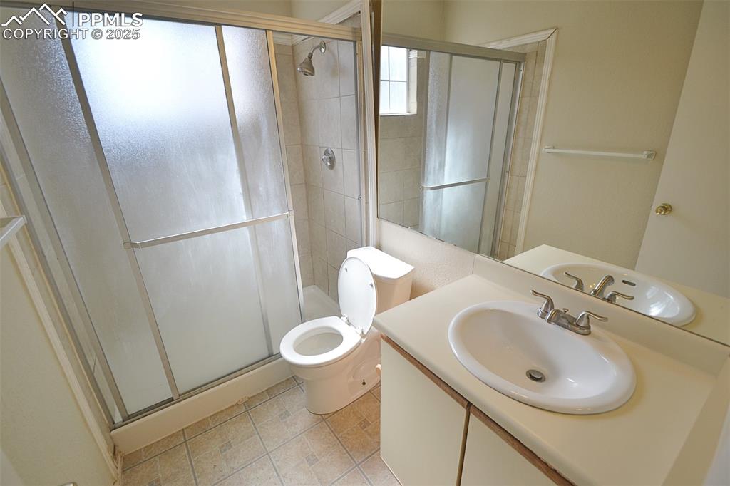 Image 18 of 31: Bathroom with vanity, a stall shower, and light tile patterned floors