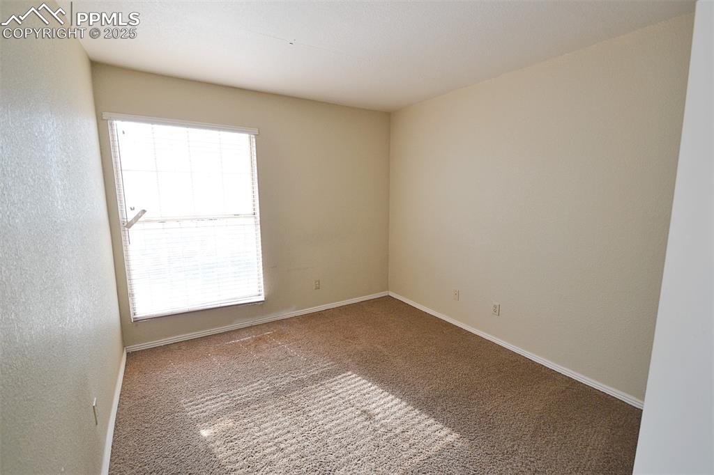 Image 19 of 31: Unfurnished room with carpet flooring and baseboards