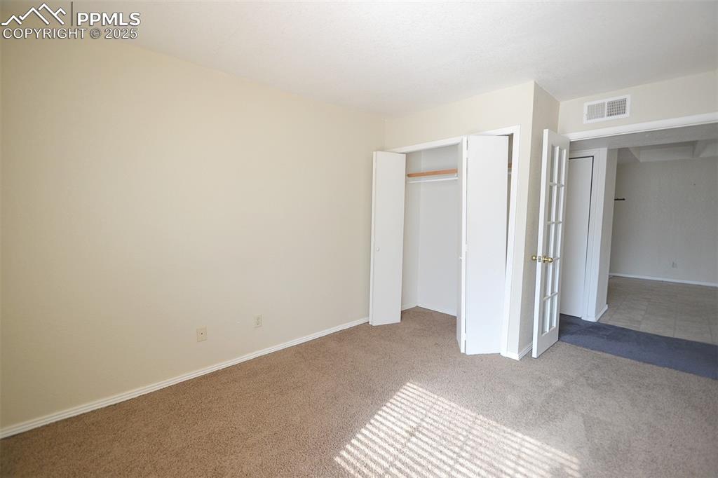 Image 20 of 31: Unfurnished bedroom with carpet floors and a closet