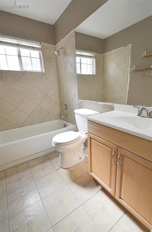 Image 23 of 31: Bathroom featuring bathing tub / shower combination, vanity, and light tile