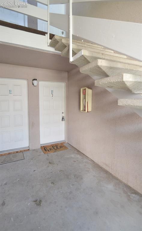 Image 5 of 31: View of exterior entry with stucco siding and a garage