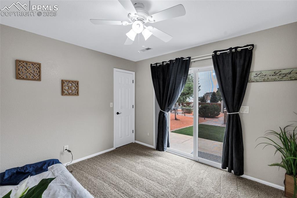 Image 12 of 39: Bedroom featuring carpet, access to exterior, and ceiling fan