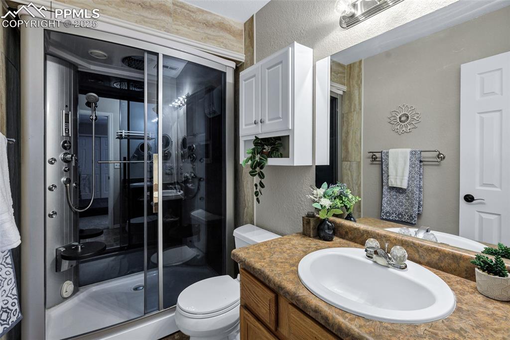 Image 16 of 39: Spa Master Bath. Vanity, and a Steam shower