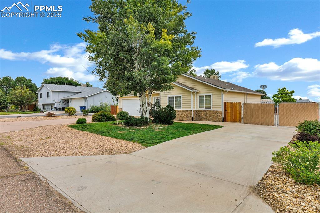 Image 2 of 39: View of front facade featuring a double-wide gate, concrete driveways