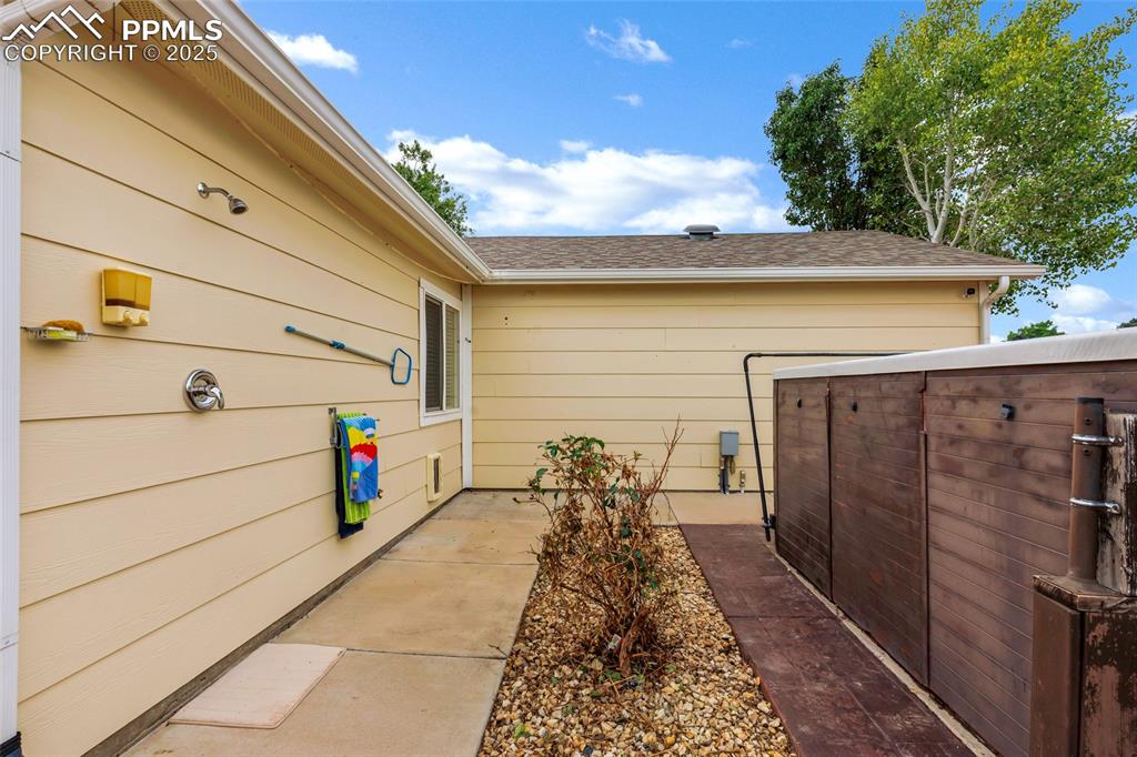 Image 22 of 39: Outdoor plumbing for a quick shower complete w/towel rack & shampoo dispens