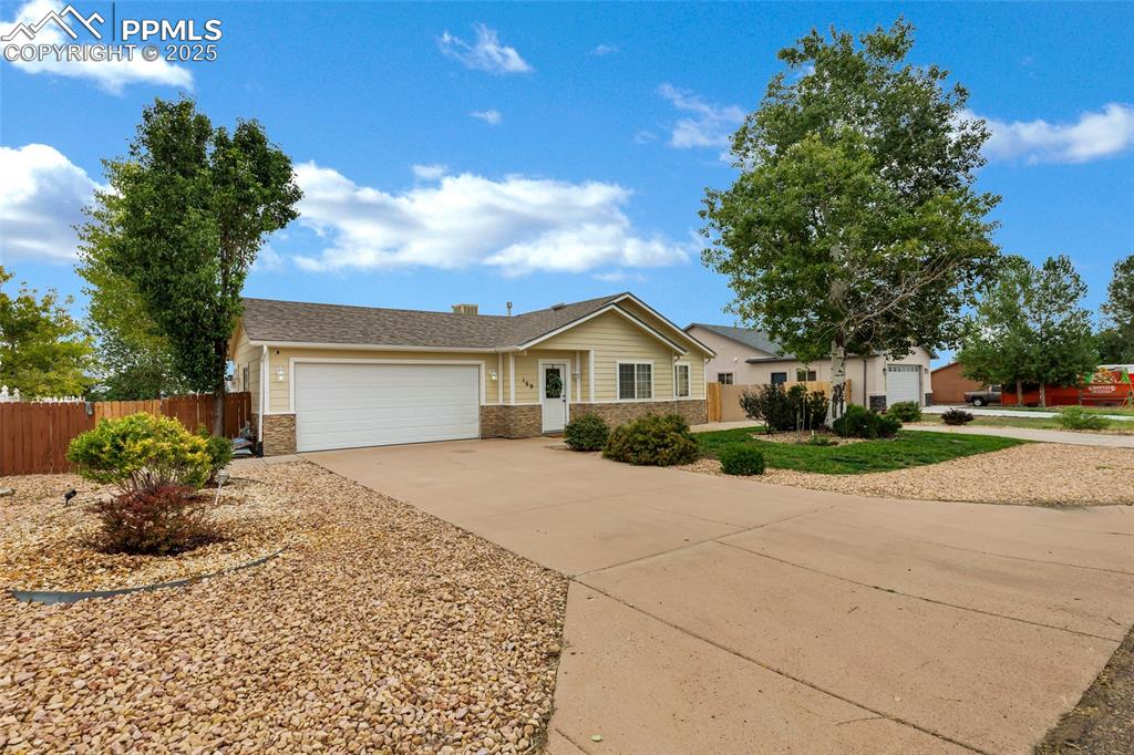 Image 3 of 39: Ranch-style house with an attached garage, concrete driveway, and brick sid