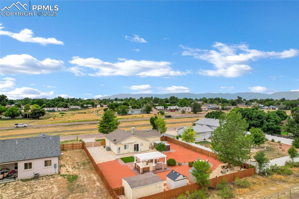 Image 36 of 39: Aerial view of residential area featuring mountains